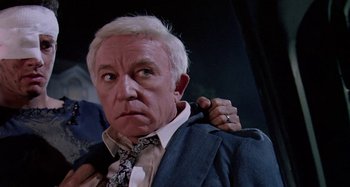 Movie still from “The 'Burbs” (1989), directed by Joe Dante – An older man holding a jacket over his shoulder; Close Up shot, Over the shoulder angle
