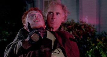 Movie still from “The 'Burbs” (1989), directed by Joe Dante – A man and a woman standing next to each other in front of a building; Close Up shot, Low angle