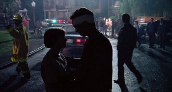 Movie still from “The 'Burbs” (1989), directed by Joe Dante – A man and a woman standing next to each other on a street; Medium shot, Low angle