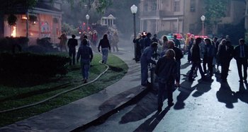 Movie still from “The 'Burbs” (1989), directed by Joe Dante – A group of people walking down a sidewalk; Wide shot, High angle