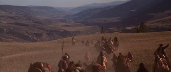 Movie still from “The 13th Warrior” (1999), directed by Michael Crichton – A group of people riding on the backs of horses; Extreme Wide shot, High angle