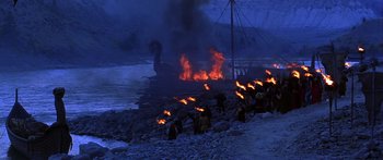 Movie still from “The 13th Warrior” (1999), directed by Michael Crichton – A group of people standing next to a fire pit; Extreme Wide shot, High angle