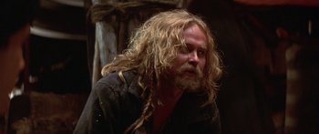 Movie still from “The 13th Warrior” (1999), directed by Michael Crichton – A man with long blonde hair and a beard; Close Up shot, Over the shoulder angle