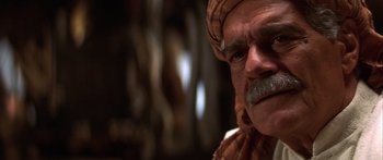 Movie still from “The 13th Warrior” (1999), directed by Michael Crichton – An old man with a beard and mustache wearing a head scarf; Close Up shot, Low angle
