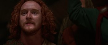 Movie still from “The 13th Warrior” (1999), directed by Michael Crichton – A person with long red hair; Close Up shot, High angle
