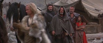 Movie still from “The 13th Warrior” (1999), directed by Michael Crichton – A group of men standing next to each other on top of a field; Medium shot, Low angle