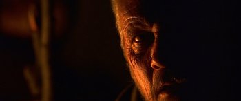 Movie still from “The 13th Warrior” (1999), directed by Michael Crichton – An old man's face is lit up by the light of a candle; Extreme Close Up shot, Low angle