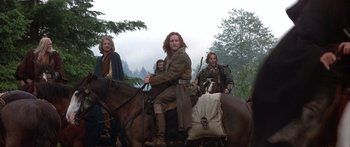 Movie still from “The 13th Warrior” (1999), directed by Michael Crichton – A group of men riding on the back of horses; Wide shot, Low angle
