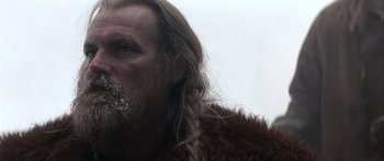 Movie still from “The 13th Warrior” (1999), directed by Michael Crichton – A person with long hair and a beard; Close Up shot, Low angle