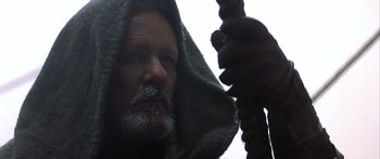 Movie still from “The 13th Warrior” (1999), directed by Michael Crichton – A man with a beard is holding a rope; Close Up shot, Low angle