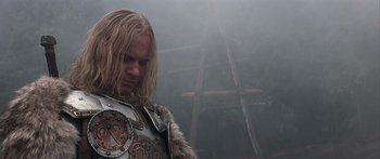 Movie still from “The 13th Warrior” (1999), directed by Michael Crichton – A man with long blonde hair wearing a suit of armor; Close Up shot, Low angle