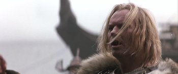 Movie still from “The 13th Warrior” (1999), directed by Michael Crichton – A person with long blonde hair; Close Up shot, Low angle