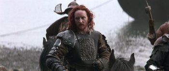 Movie still from “The 13th Warrior” (1999), directed by Michael Crichton – A red headed man in a black and brown armor; Medium shot, Low angle