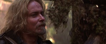 Movie still from “The 13th Warrior” (1999), directed by Michael Crichton – A person with long hair and a beard; Close Up shot, Over the shoulder angle