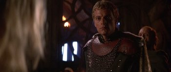 Movie still from “The 13th Warrior” (1999), directed by Michael Crichton – A person wearing a chain mail armor; Close Up shot, Low angle