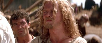 Movie still from “The 13th Warrior” (1999), directed by Michael Crichton – A person with long hair and a beard; Close Up shot, Low angle