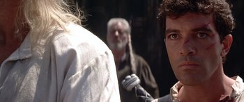 Movie still from “The 13th Warrior” (1999), directed by Michael Crichton – A man with long white hair is looking at another man with long white hair; Close Up shot, Over the shoulder angle