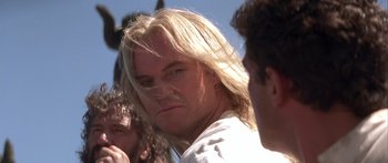 Movie still from “The 13th Warrior” (1999), directed by Michael Crichton – A person with long blonde hair; Close Up shot, Low angle