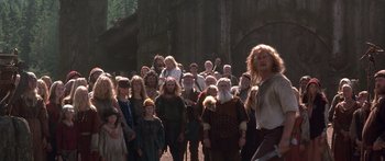 Movie still from “The 13th Warrior” (1999), directed by Michael Crichton – A group of people dressed in costumes in a forest; Wide shot, Low angle