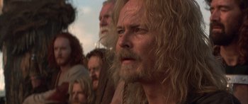 Movie still from “The 13th Warrior” (1999), directed by Michael Crichton – A person with long hair and a beard; Close Up shot, Low angle