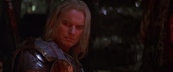 Movie still from “The 13th Warrior” (1999), directed by Michael Crichton – A person with long blonde hair; Close Up shot, Low angle