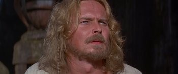 Movie still from “The 13th Warrior” (1999), directed by Michael Crichton – A person with long hair and a beard; Close Up shot, Low angle