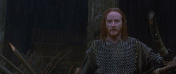 Movie still from “The 13th Warrior” (1999), directed by Michael Crichton – A man in chain mail standing next to a tree; Close Up shot, Low angle