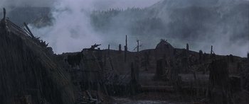 Movie still from “The 13th Warrior” (1999), directed by Michael Crichton – A dark picture of a forest with fog in the background; Extreme Wide shot, High angle