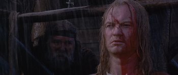 Movie still from “The 13th Warrior” (1999), directed by Michael Crichton – A man and a woman with blood all over their faces; Close Up shot, Over the shoulder angle