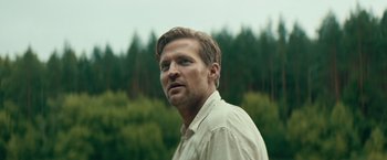 Movie still from “Out Stealing Horses” (2019), directed by Hans Petter Moland – A person wearing a white shirt; Close Up shot, Low angle