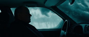 Movie still from “Out Stealing Horses” (2019), directed by Hans Petter Moland – A man sitting in the driver's seat of a car looking out the window; Close Up shot, Over the shoulder angle