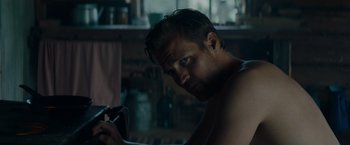 Movie still from “Out Stealing Horses” (2019), directed by Hans Petter Moland – A person holding a cell phone; Close Up shot, Over the shoulder angle