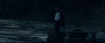Movie still from “Out Stealing Horses” (2019), directed by Hans Petter Moland – A man and a woman standing on a dock; Wide shot, High angle