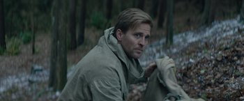 Movie still from “Out Stealing Horses” (2019), directed by Hans Petter Moland – A person wearing a hooded jacket; Close Up shot, Over the shoulder angle