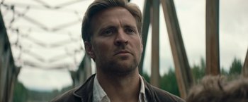 Movie still from “Out Stealing Horses” (2019), directed by Hans Petter Moland – A person wearing a jacket; Close Up shot, Low angle