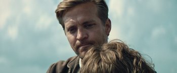 Movie still from “Out Stealing Horses” (2019), directed by Hans Petter Moland – A person with a dog on his shoulder; Close Up shot, Over the shoulder angle