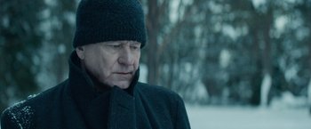 Movie still from “Out Stealing Horses” (2019), directed by Hans Petter Moland – A man wearing a black coat and a black hat; Close Up shot, Over the shoulder angle