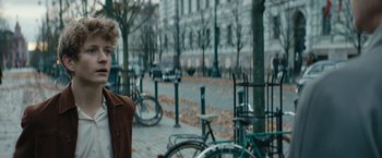 Movie still from “Out Stealing Horses” (2019), directed by Hans Petter Moland – Many bicycles parked on the sidewalk; Close Up shot, Over the shoulder angle