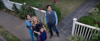 Movie still from “The 5th Wave” (2016), directed by J Blakeson – A man and two women and a child standing on a porch; Wide shot, High angle