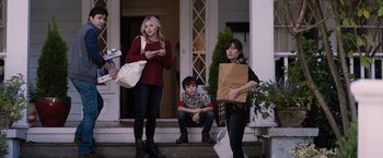 Movie still from “The 5th Wave” (2016), directed by J Blakeson – A group of people standing on the steps of a house; Medium shot, Over the shoulder angle
