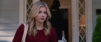 Movie still from “The 5th Wave” (2016), directed by J Blakeson – A beautiful young lady wearing a red sweater; Close Up shot, Over the shoulder angle