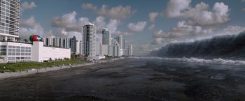 Movie still from “The 5th Wave” (2016), directed by J Blakeson – A view of a beach and a city skyline; Extreme Wide shot, High angle