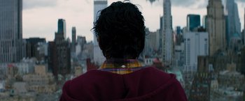 Movie still from “The 5th Wave” (2016), directed by J Blakeson – A man in a plaid shirt looking out over a city; Close Up shot, High angle