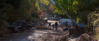 Movie still from “The 5th Wave” (2016), directed by J Blakeson – A group of people walking down a dirt road; Extreme Wide shot, High angle