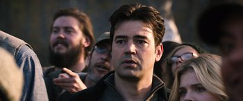 Movie still from “The 5th Wave” (2016), directed by J Blakeson – A person wearing a hat and looking at the camera; Close Up shot, Over the shoulder angle