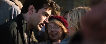 Movie still from “The 5th Wave” (2016), directed by J Blakeson – A group of people standing around each other talking to each other; Close Up shot, Over the shoulder angle