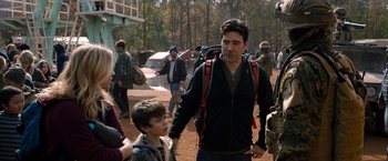 Movie still from “The 5th Wave” (2016), directed by J Blakeson – A group of people walking on a dirt road; Medium shot, Over the shoulder angle
