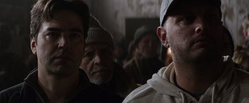 Movie still from “The 5th Wave” (2016), directed by J Blakeson – A group of men standing next to each other in a room; Close Up shot, Over the shoulder angle