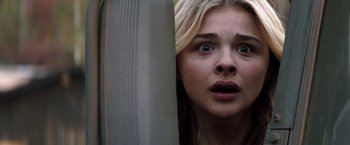 Movie still from “The 5th Wave” (2016), directed by J Blakeson – A girl with a surprised look on her face; Close Up shot, Low angle