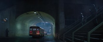 Movie still from “The 5th Wave” (2016), directed by J Blakeson – A school bus driving through a tunnel at night; Extreme Wide shot, Low angle
